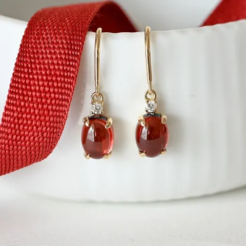 ovala granat diamantörhängen i 14 karat guld med granat och diamant