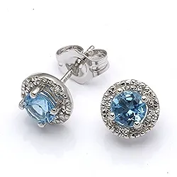 Runda örhängen i 9 karat vitguld med topaser och zirkoner