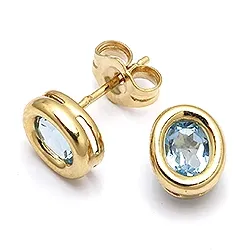 Ovala örhängestift i 9 karat guld med topaser