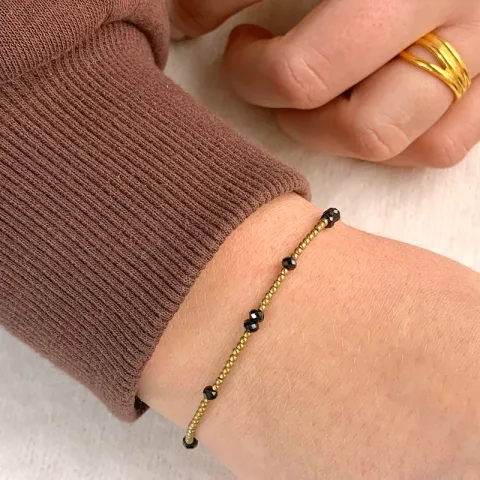 förgylld sten armband med hematite og spinell sten.