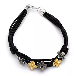 sort armband i läder med blommaberlock i förgyllt och rhodinerat silver