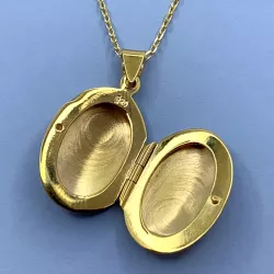 oval medaljong i förgyllt silver